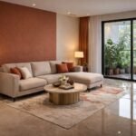 A high-end, photorealistic interior shot of a modern Indian living room. The room features a warm color palette (terracotta and cream), a sleek modular sofa, a large windows showing a glimpse of a lush balcony, and a stunning marble floor with a mirror-like finish. Subtle traditional Indian accents like a brass lamp and a contemporary hand-tufted rug. The lighting is soft, warm, and inviting. 8k resolution, architectural photography style.