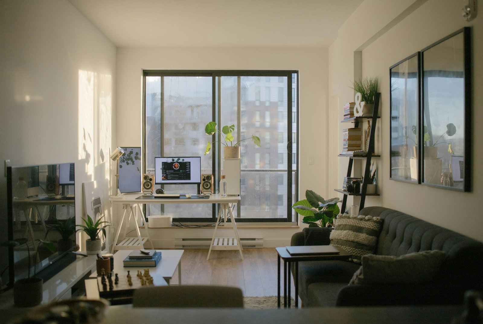 Functional home office with desk, comfortable chair, task lighting and natural light