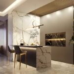 Modern kitchen with neutral cabinetry, stone island and warm layered lighting